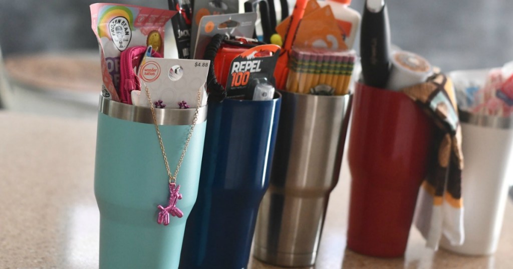 tumbler gift ideas with cups filled with goodies 