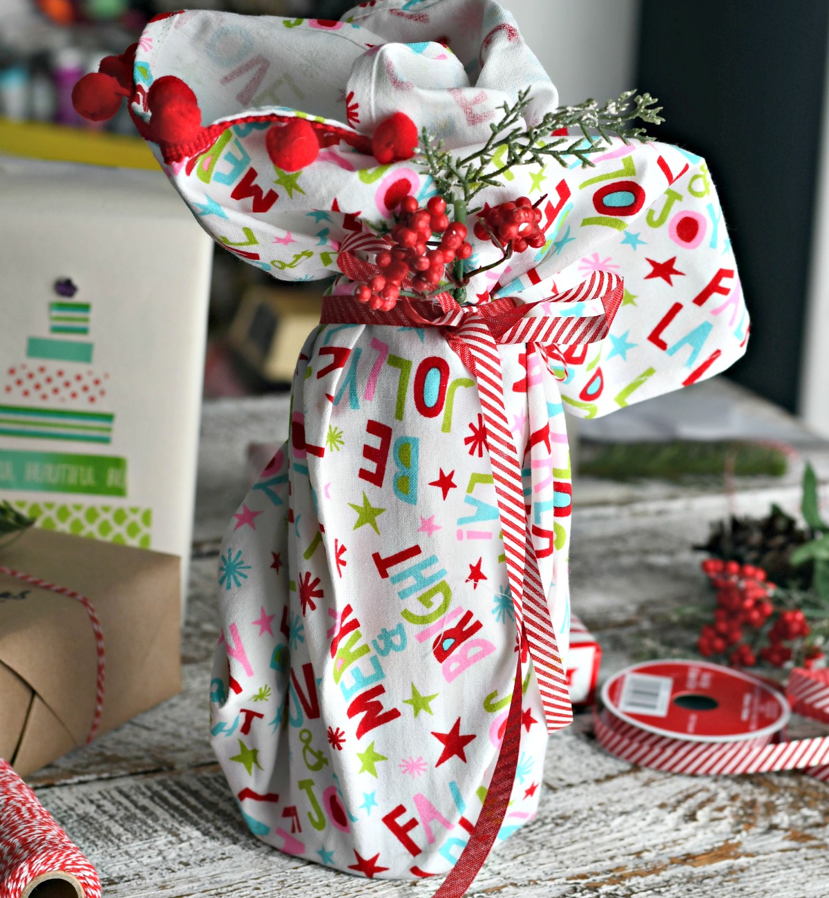 holiday dish towel used to wrap wine bottle