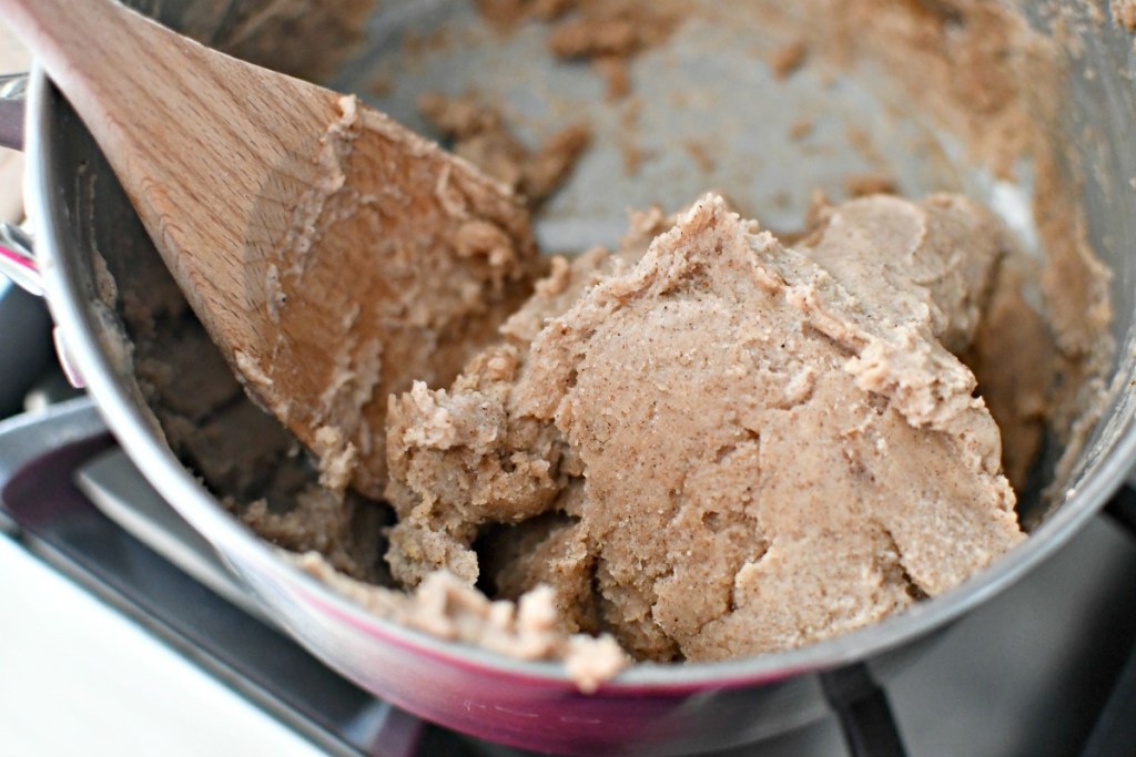 mixing gingerbread play dough on the stove