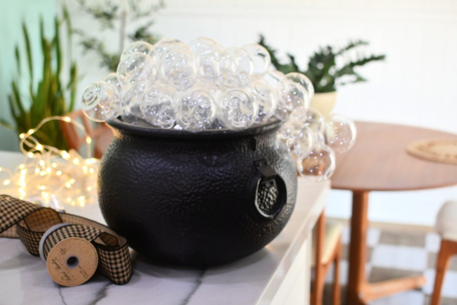 black plastic cauldron with clear ornaments
