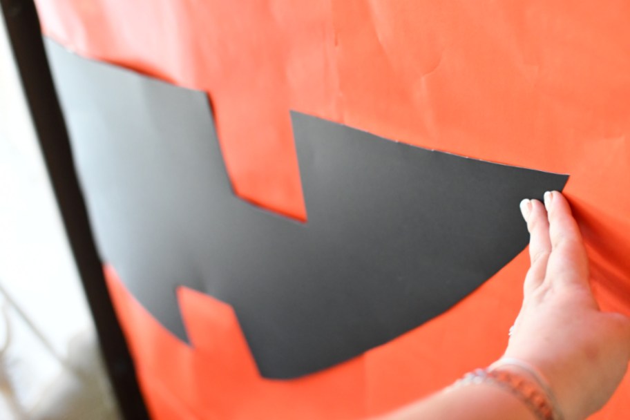 Woman making a DIY Halloween Decoration of a jack-o-lantern