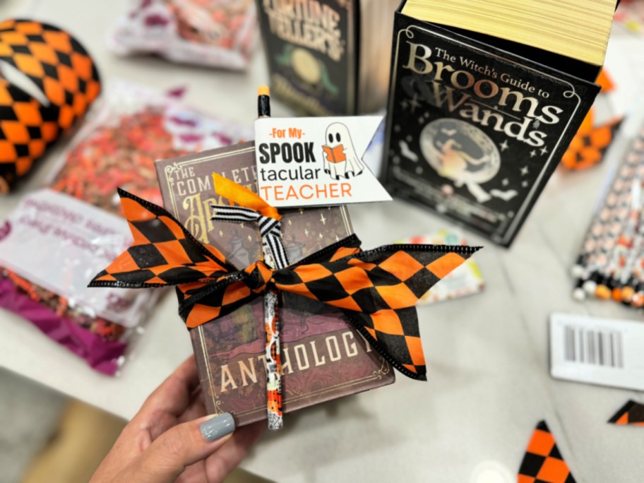 holding a spooktacular teacher book box gift 