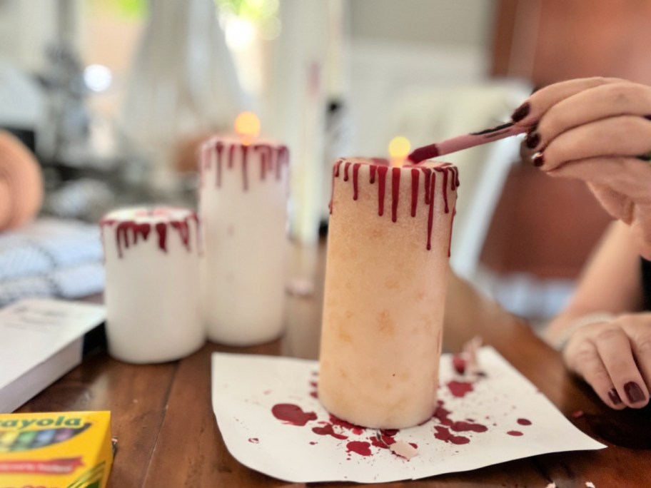 melting a red crayon on a candle 