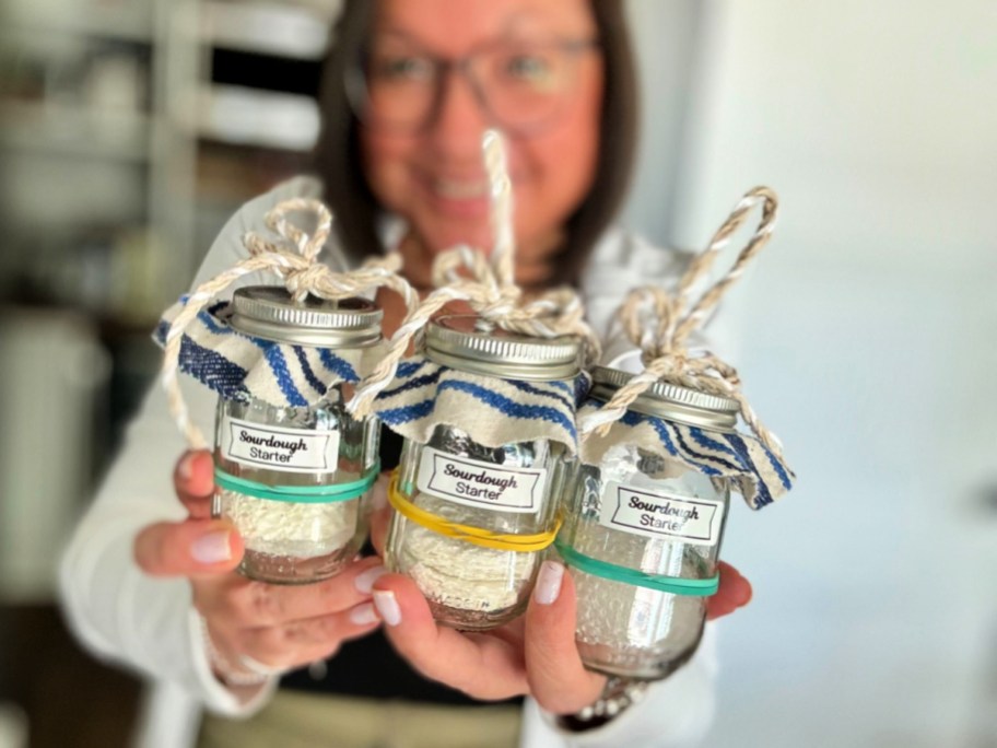 woman holding 3 sourdough starter ornaments