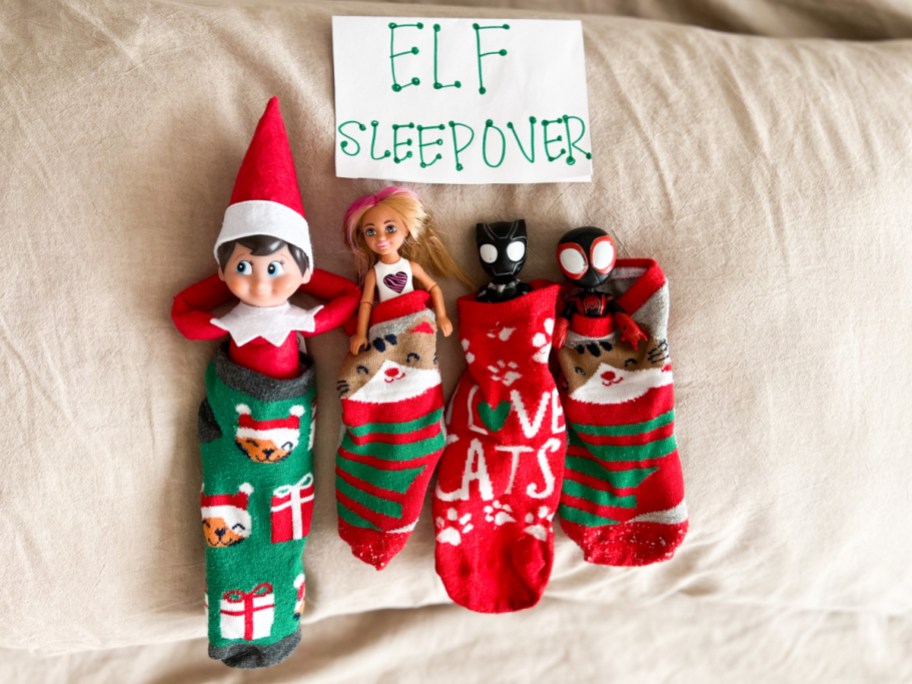 elf and dolls laying in socks