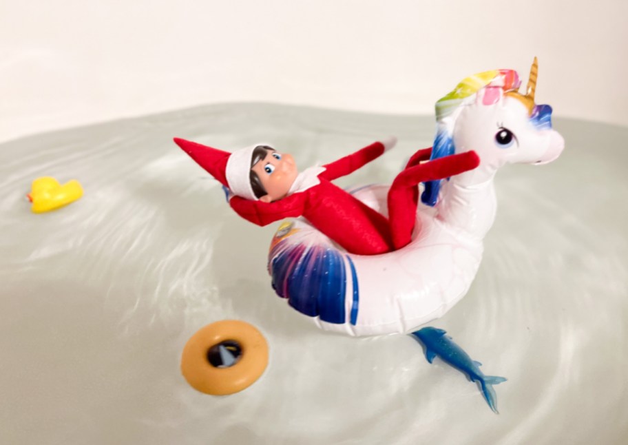 elf on a unicorn inflatable in water