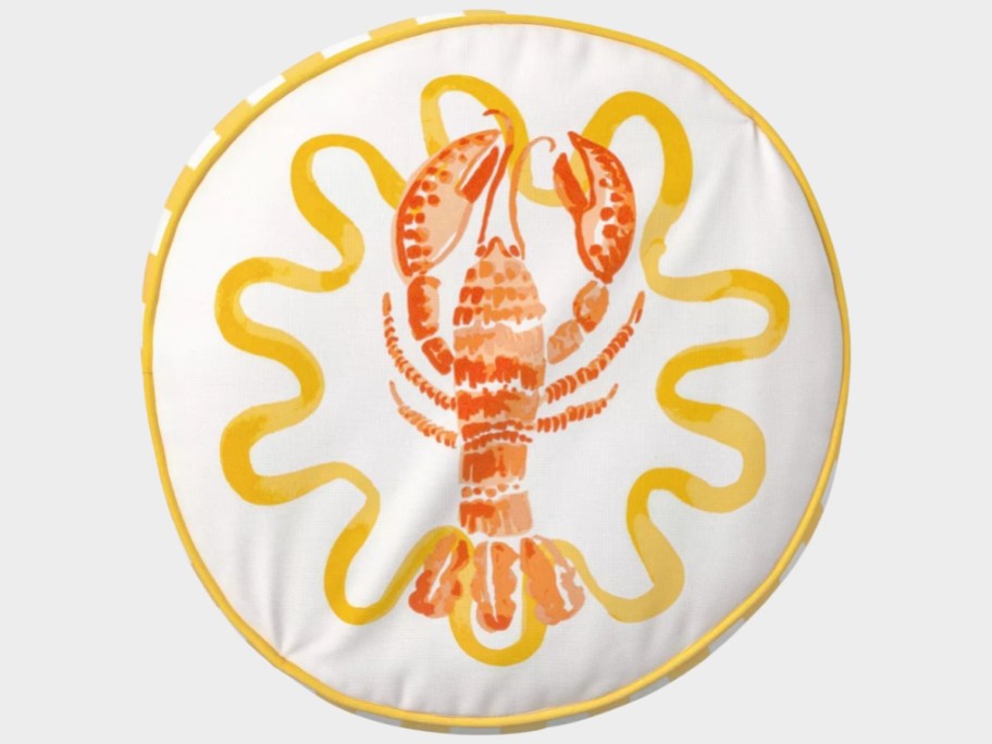 a large round throw pillow with a lobster and yellow trim