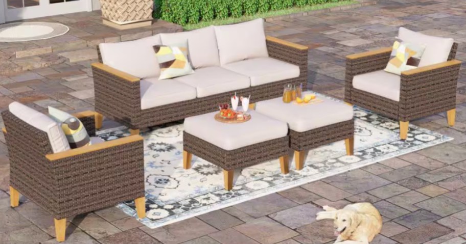 a large wicker patio furniture set on a back patio