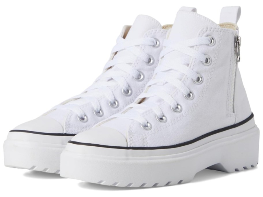 a pair of white platform Chuck Taylor kids shoes