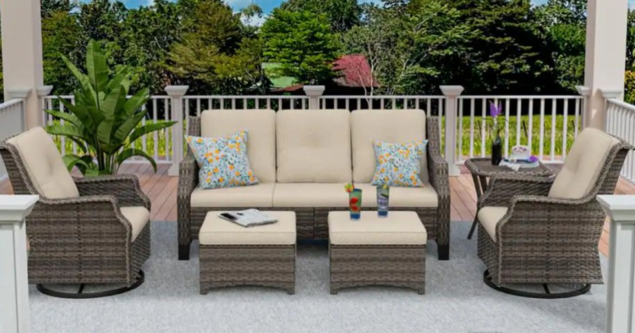 a large wicker patio furniture set on a back deck