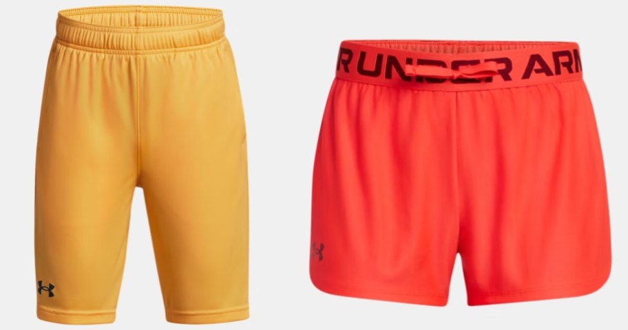 a pair of yellow boy's Under Armour shorts and a pair of orange girl's Under Armour shorts