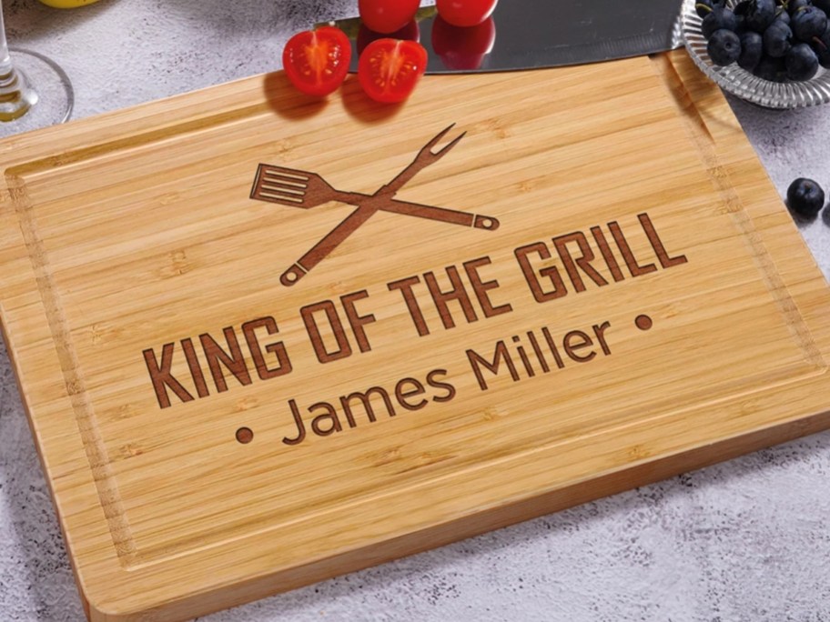 a personalize wood cutting board that says "king of the grill"