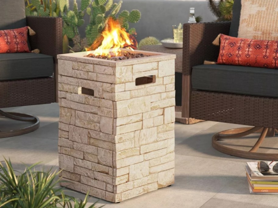 a rectangular stone fire pit on a patio