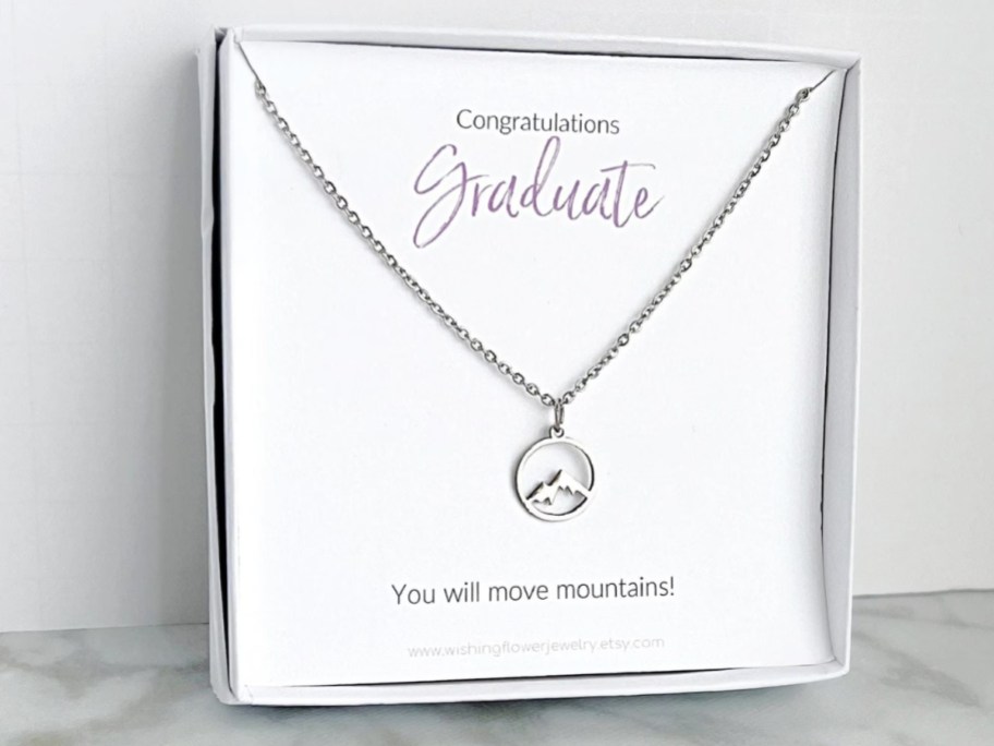 a box with a mountain charm silver necklace