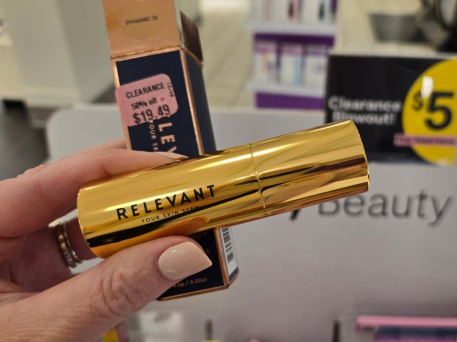 hand holding a tube and box for a relevant foundation stick in store