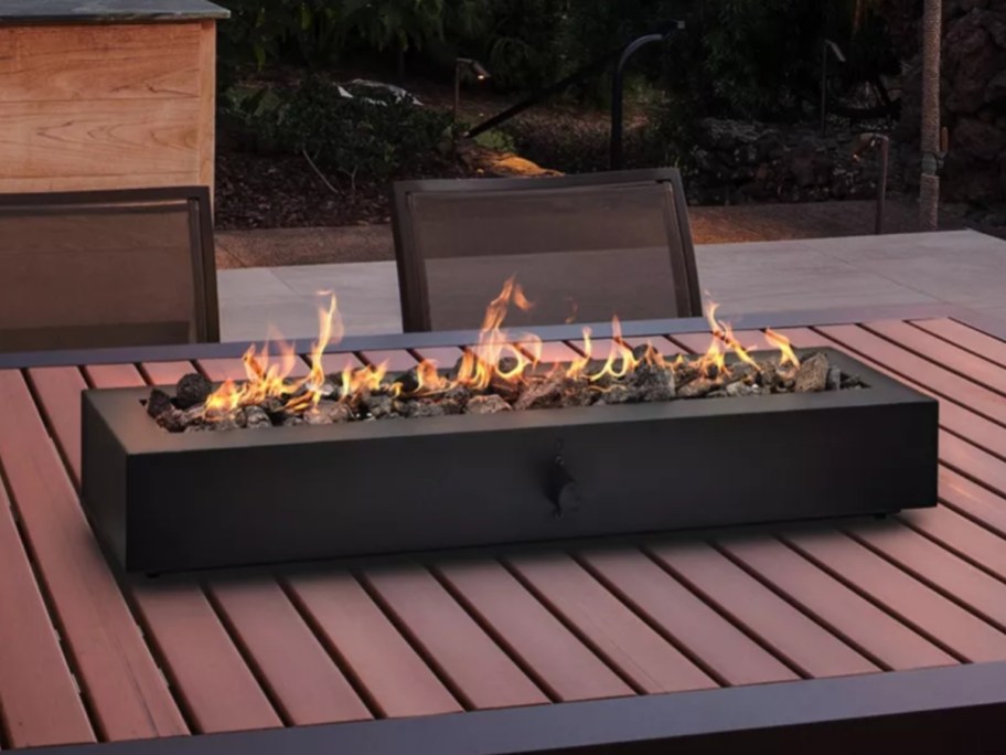 a large black tabletop firepit on a patio table