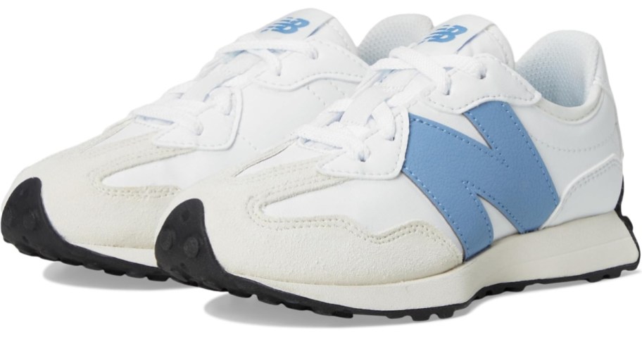 a pair of kids New Balance shoes in white with blue accents