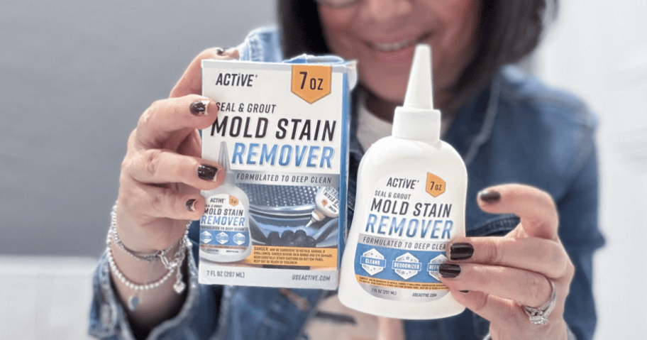 woman holding up a bottle of Active Mold Grout Gel Cleaner