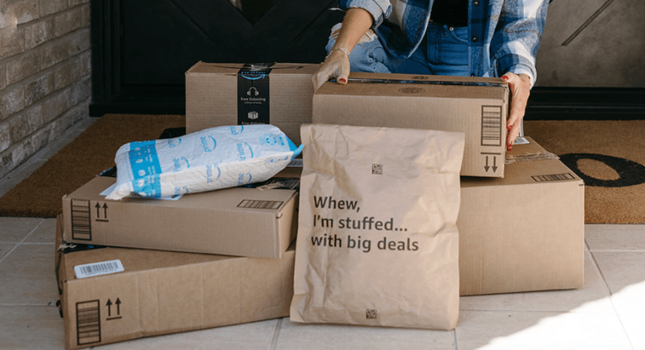 Amazon packages on front porch, person reaching for them
