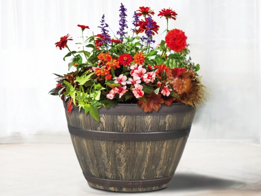 large whisky barrel planter with flowers in it