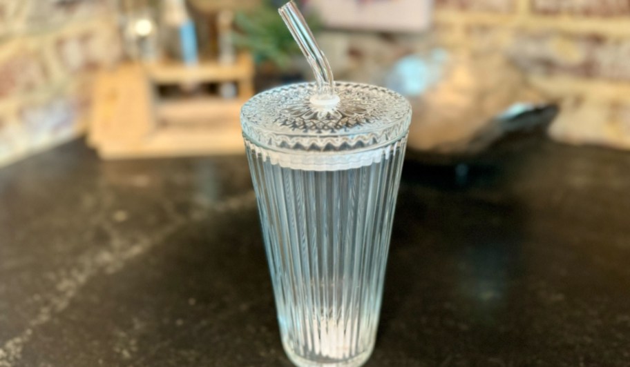 better homes & gardens glass tumbler with lid and straw on countertop
