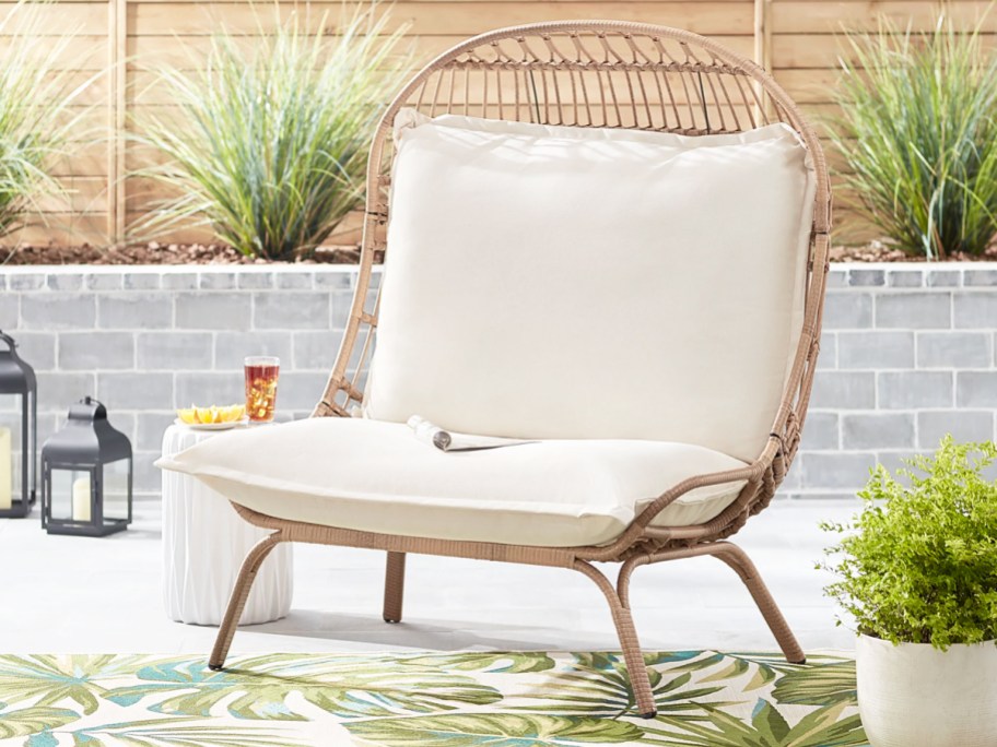 wicker patio chair with white cushions