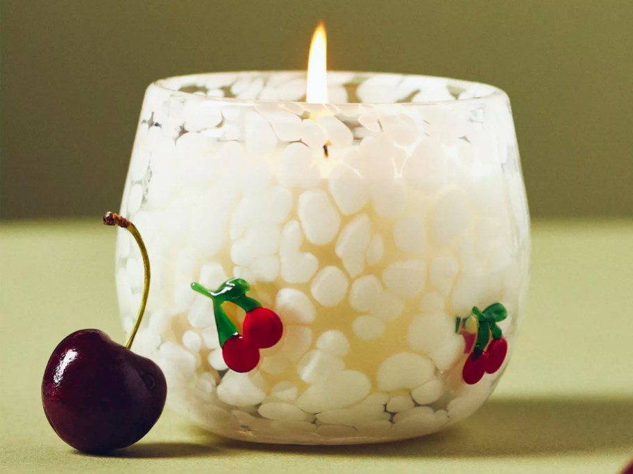 white bubble glass candle with mini cherries on the sides