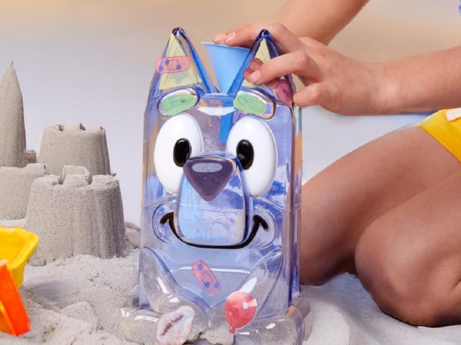 Kid playing with bluey sand kit
