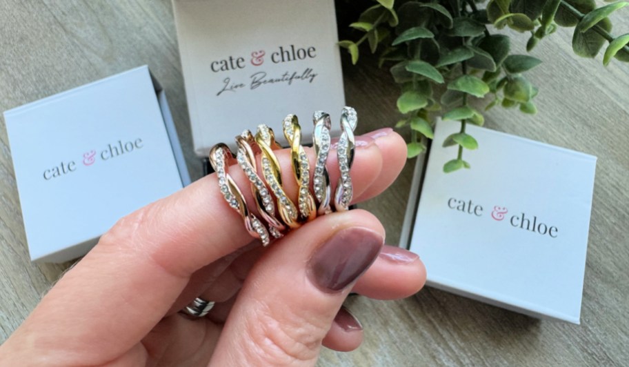 Cate & Chloe Earrings on a woman's finger