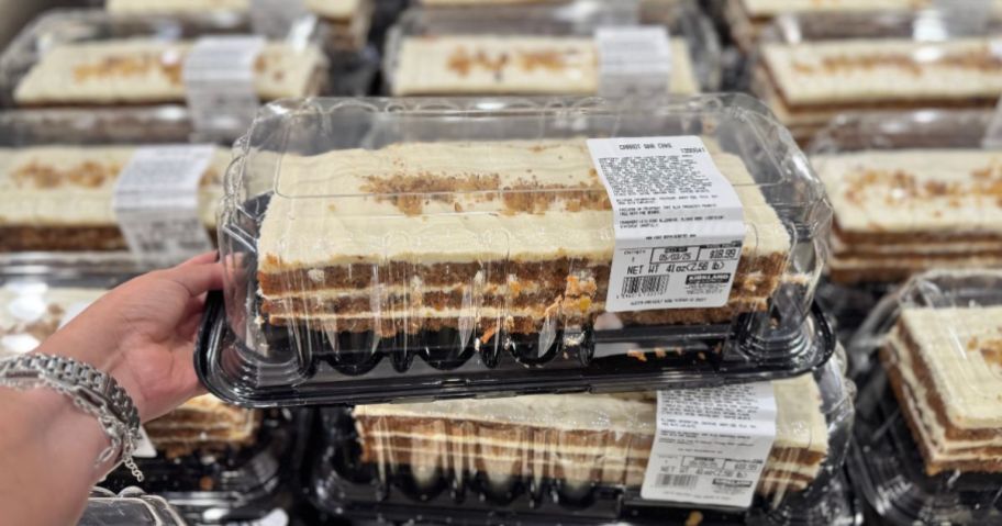 a person holding a carrot cake