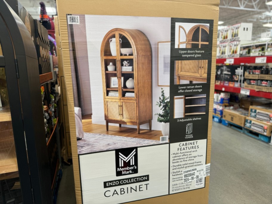 box on store floor with natural colored wood arched cabinet