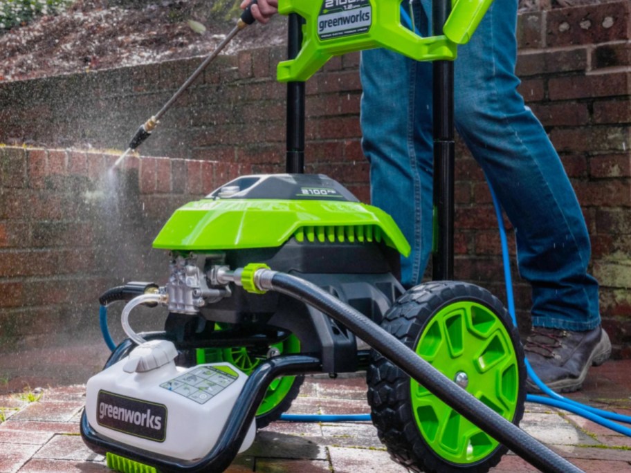 someone using a Greenworks Pressure Washer