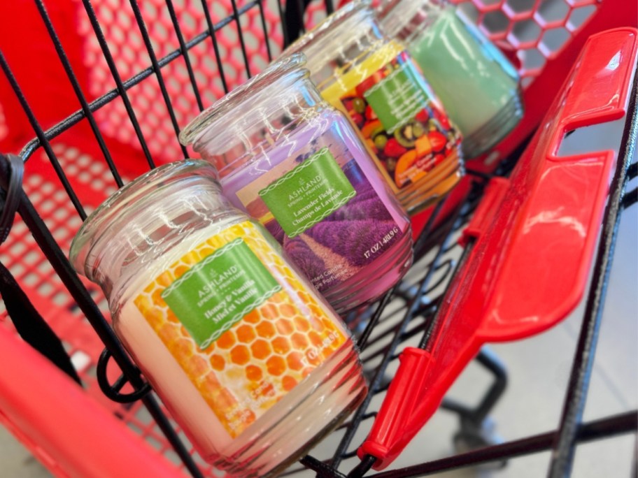 various scents of Ashland Jar Candles in a red Michaels shopping cart
