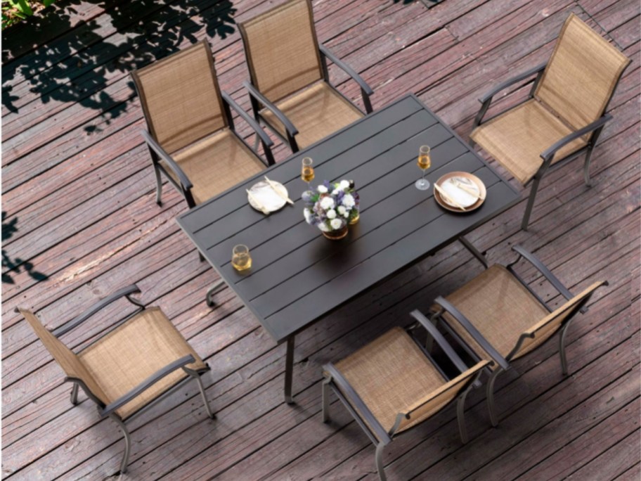 an outdoor patio dining set with a table and chairs