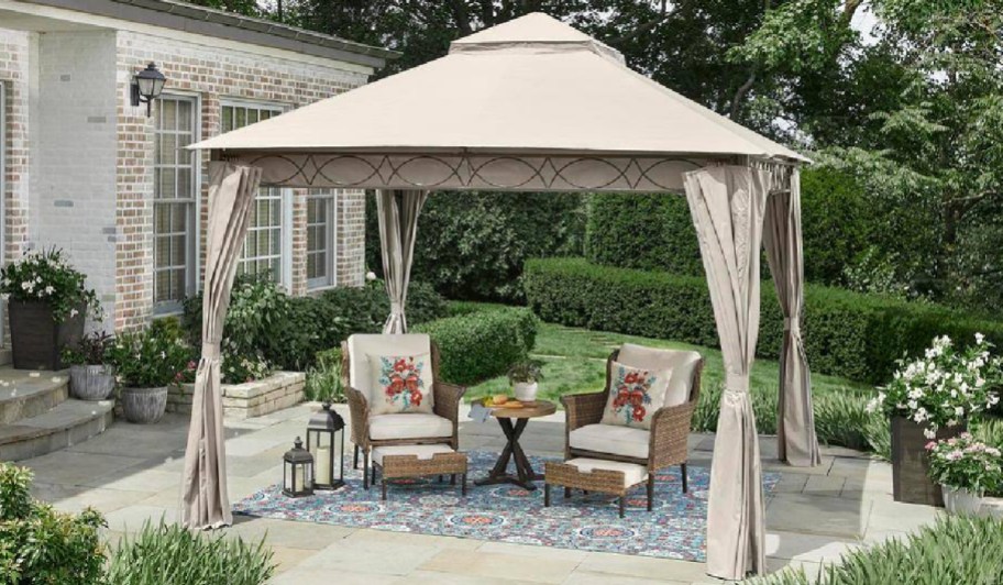gazebo with curtains and chairs underneath 