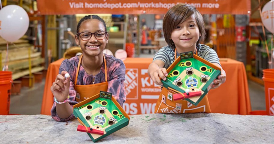 kids showing their Home Depot Workshop crafts
