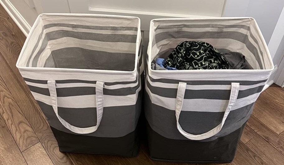 2 large grey and white striped laundry hampers in a hallway