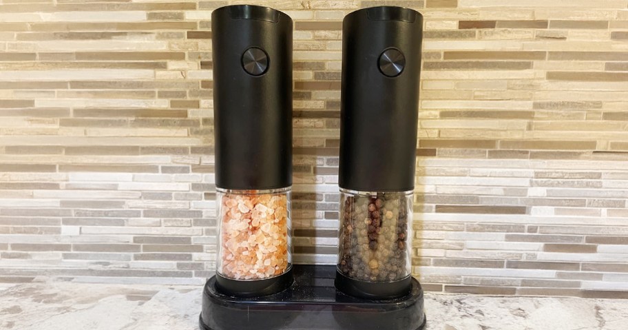 Salt and Pepper Grinder Set in front of backsplash on counter
