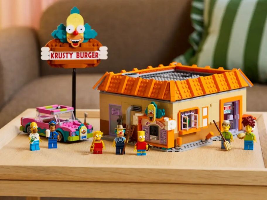 A Simpsons Krusty Burger LEGO set on a coffee table