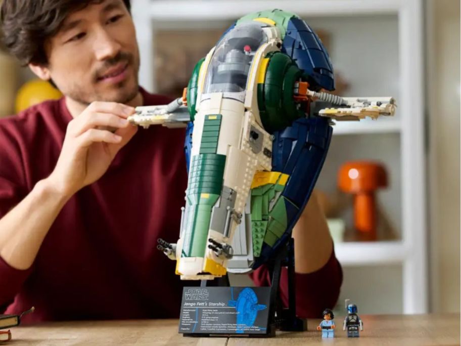 A man assembling a LEGO starship