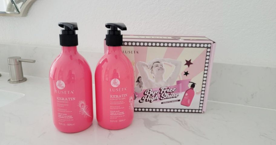 pink bottles of luseta shampoo and conditioner