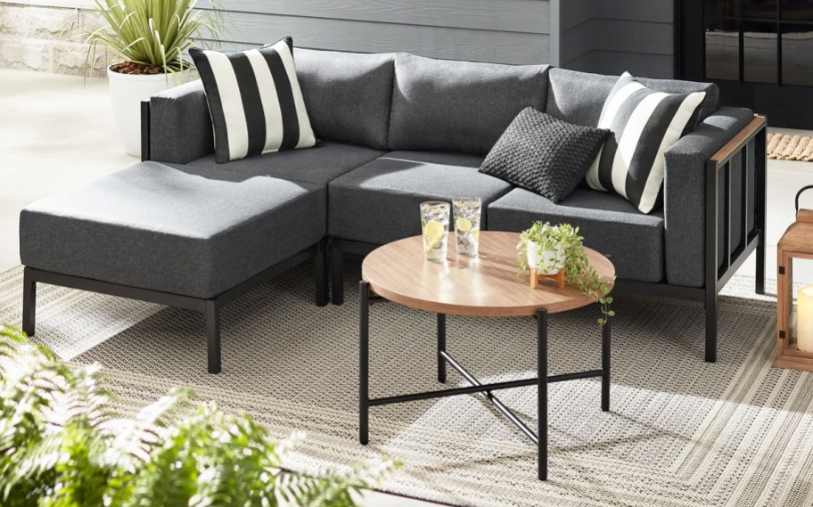 a gray 4 piece sectional with table on a patio
