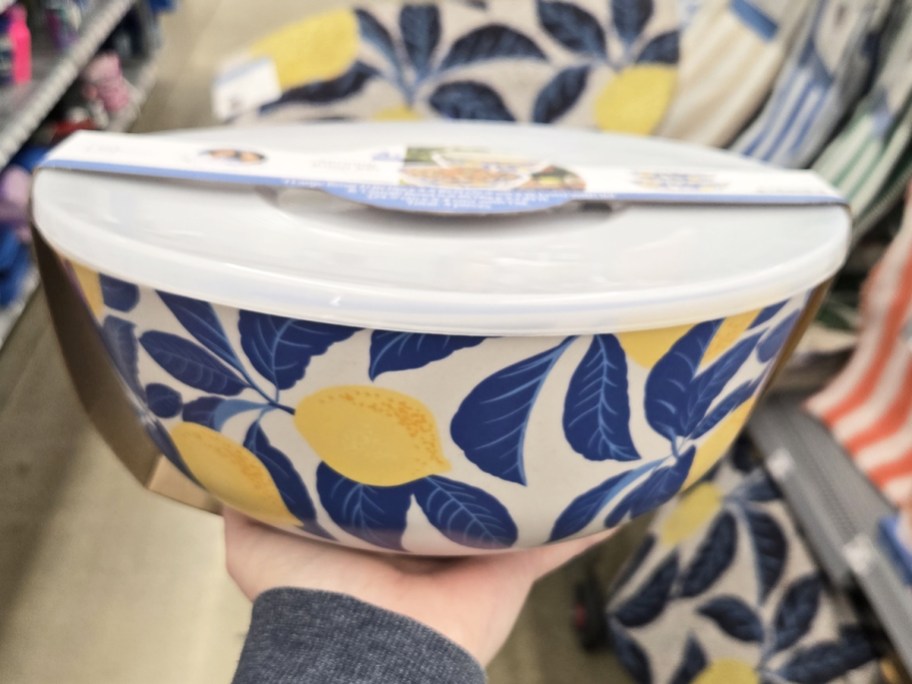 hand holding up a blue and yellow lemon print serving bowl set