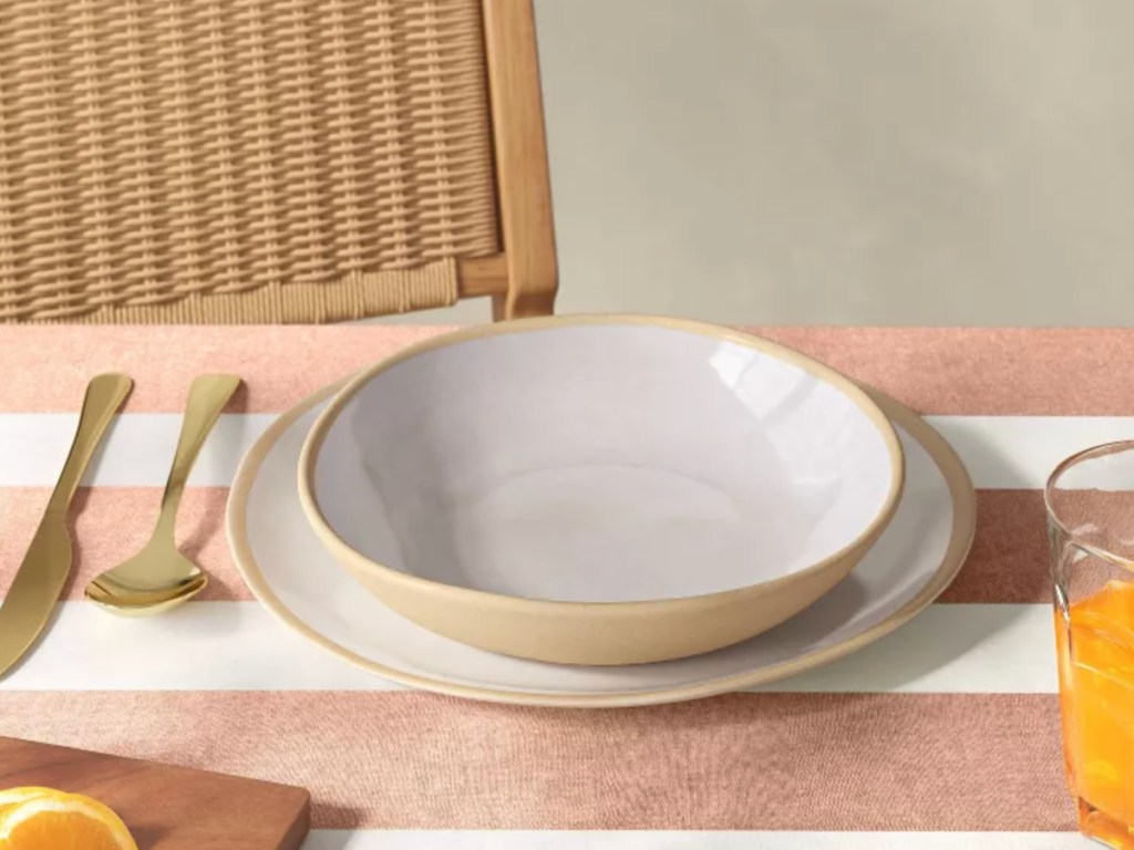 Ivory melamine bowl and plate on table next to silverware