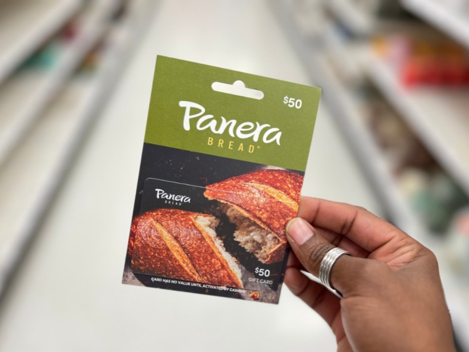 holding a panera gift card