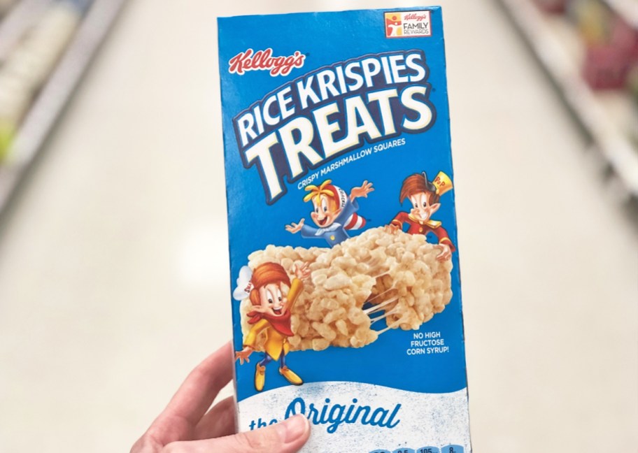 hand holding a blue box of Rice Krispies Treats in store