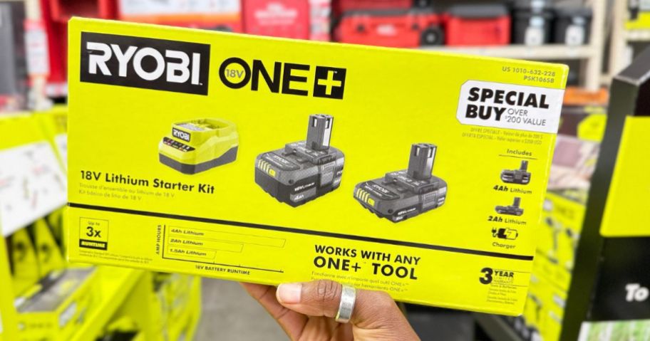 Hand holding up a Ryobi One+ Lithium Battery Starter Kit