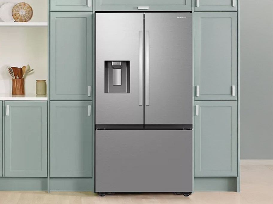 Samsung 31 cu. ft. French Door Refrigerator in a kitchen with cabinets