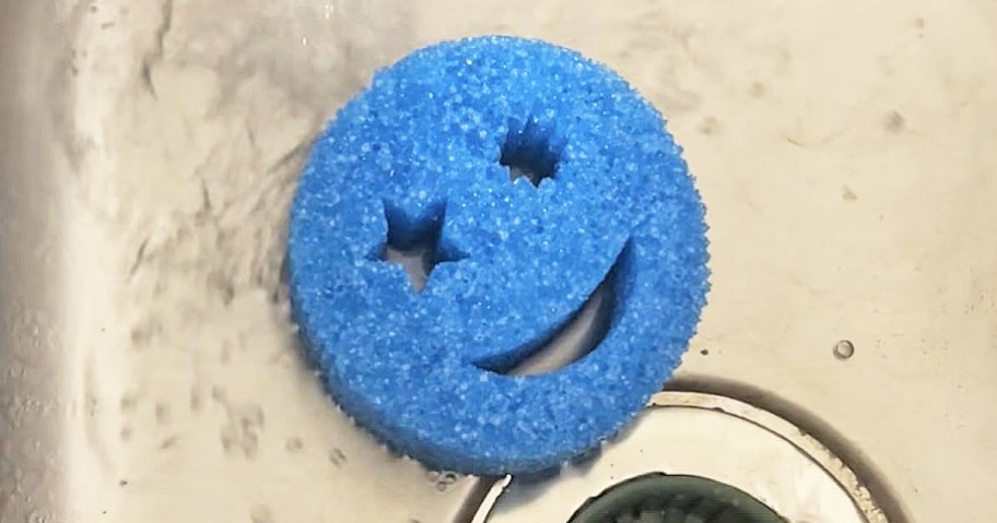 blue smiley face sponge in sink