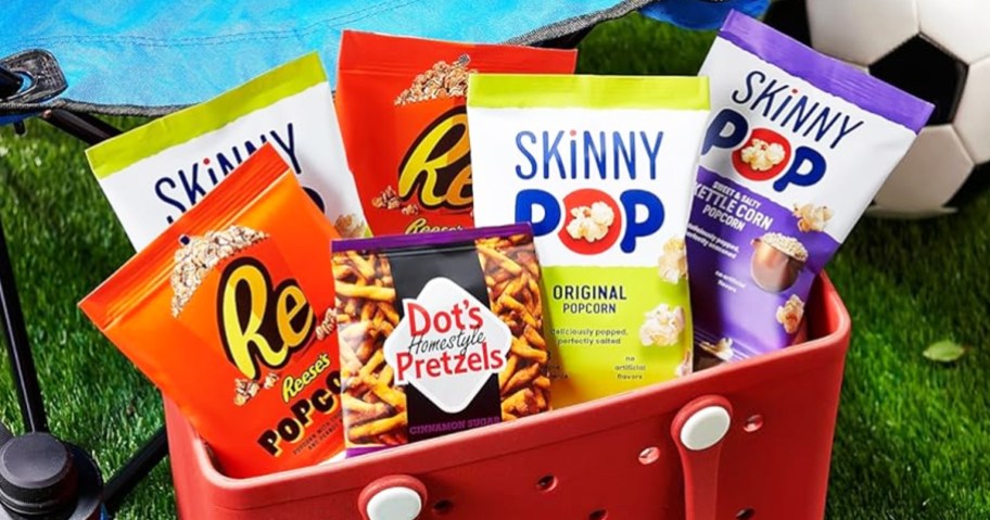 bags of skinny pop, dot's pretzels, and reese's pretzels in a red tote bag
